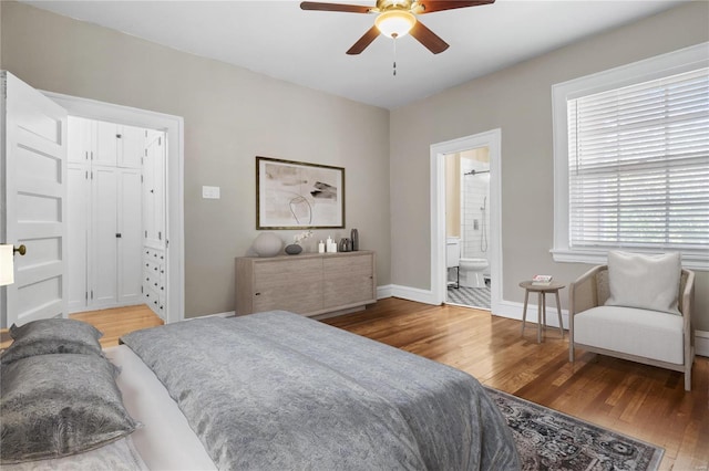 bedroom with ceiling fan, hardwood / wood-style flooring, and ensuite bathroom