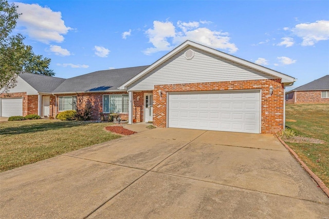 ranch-style house featuring a front lawn and a garage