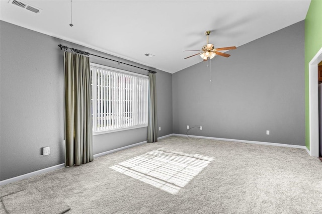 carpeted empty room featuring ceiling fan and vaulted ceiling