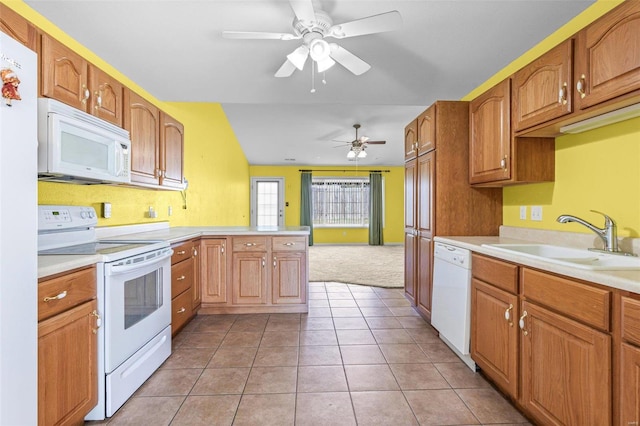 kitchen featuring kitchen peninsula, sink, light tile patterned floors, white appliances, and ceiling fan