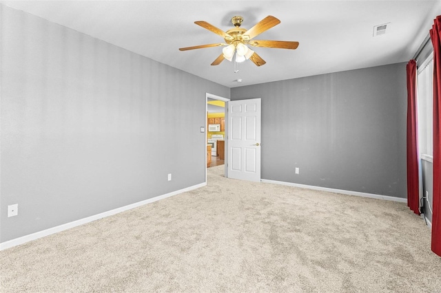 interior space with light colored carpet and ceiling fan