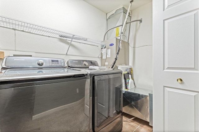 laundry room with washer and dryer and light tile patterned flooring