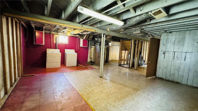 basement featuring washing machine and dryer and water heater