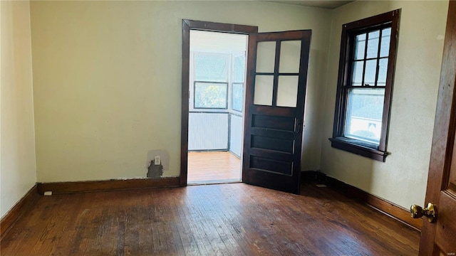 entrance foyer with dark hardwood / wood-style floors and a healthy amount of sunlight