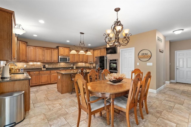 dining space with sink and a notable chandelier