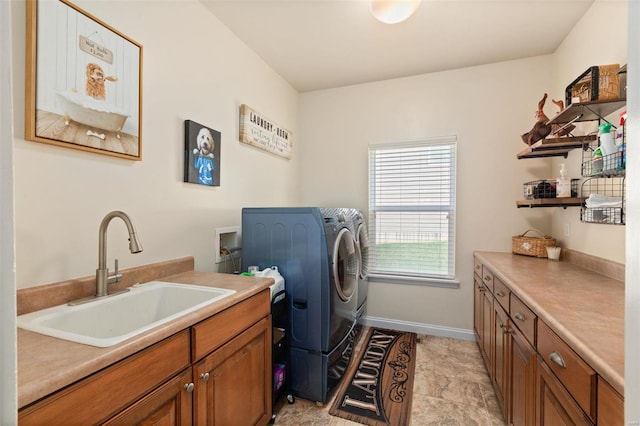 washroom with independent washer and dryer, cabinets, and sink