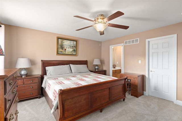 carpeted bedroom with ceiling fan and ensuite bath