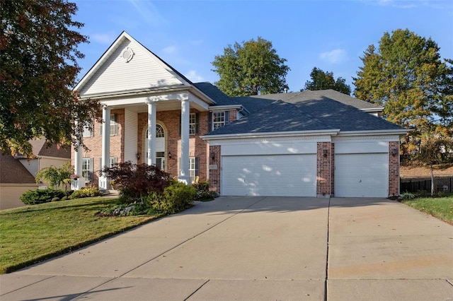 neoclassical / greek revival house with a front yard and a garage