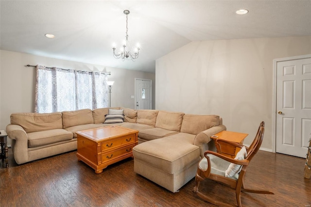 living room featuring lofted ceiling, dark wood-type flooring, and a chandelier