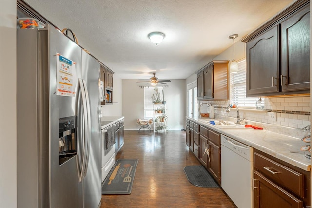 kitchen featuring dark brown cabinets, hanging light fixtures, stainless steel fridge with ice dispenser, dishwasher, and dark hardwood / wood-style floors