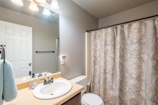 bathroom with vanity, toilet, and a shower with curtain