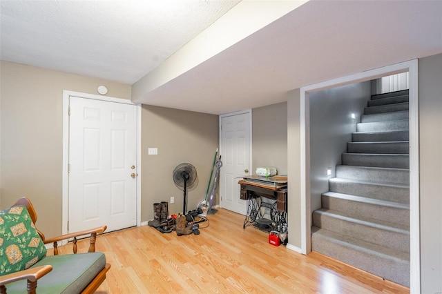 interior space featuring a textured ceiling and hardwood / wood-style flooring