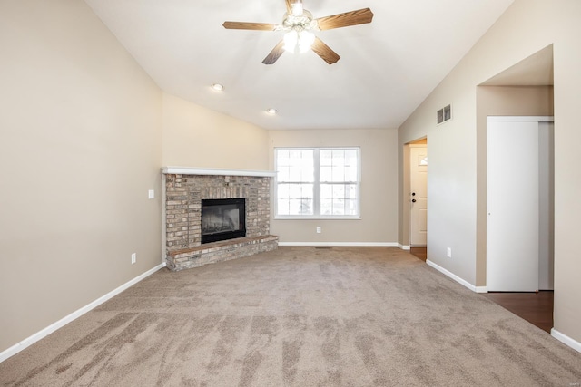 unfurnished living room with carpet flooring, ceiling fan, lofted ceiling, and a brick fireplace