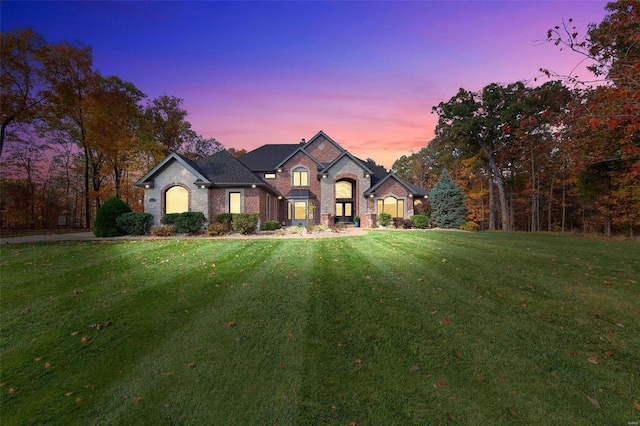 french country style house featuring a lawn