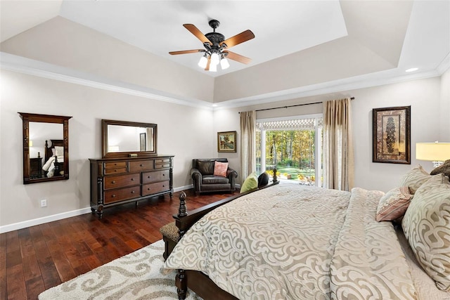 bedroom featuring ceiling fan, crown molding, dark hardwood / wood-style flooring, and a raised ceiling