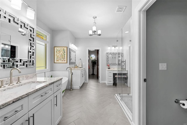 bathroom featuring vanity, a notable chandelier, independent shower and bath, and parquet flooring