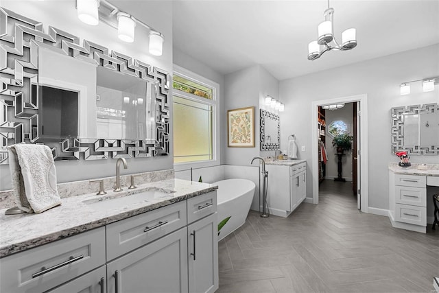 bathroom featuring vanity, an inviting chandelier, independent shower and bath, and parquet flooring