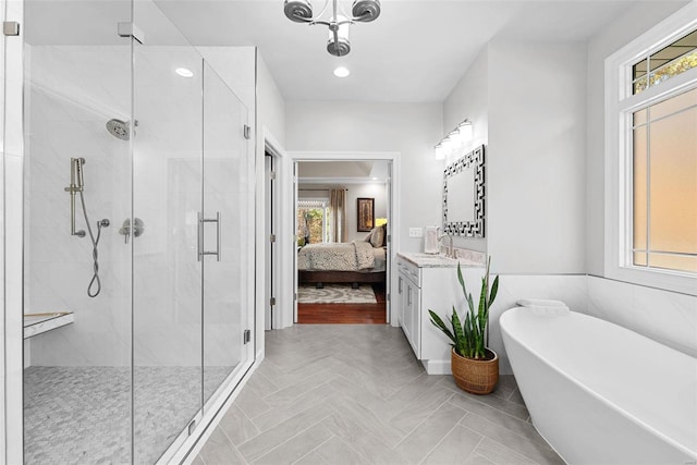 bathroom featuring vanity and shower with separate bathtub