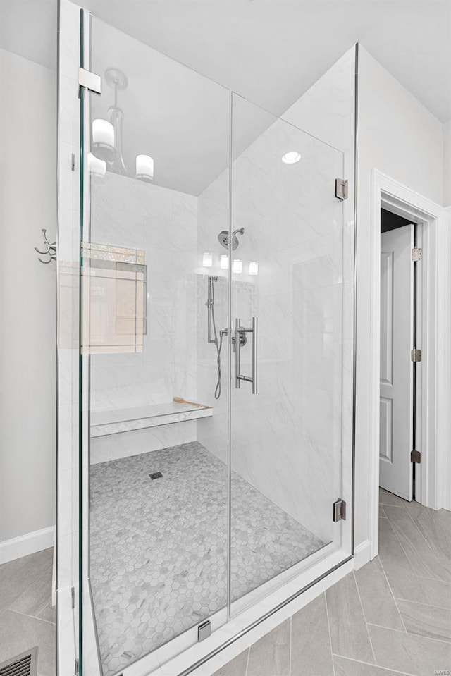 bathroom featuring an enclosed shower and tile patterned flooring