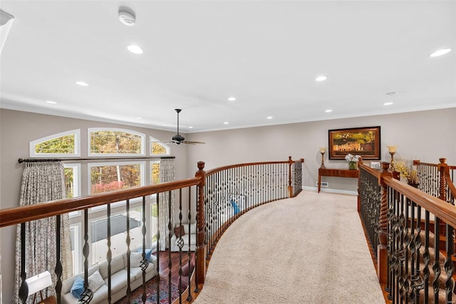 hallway featuring crown molding and carpet flooring