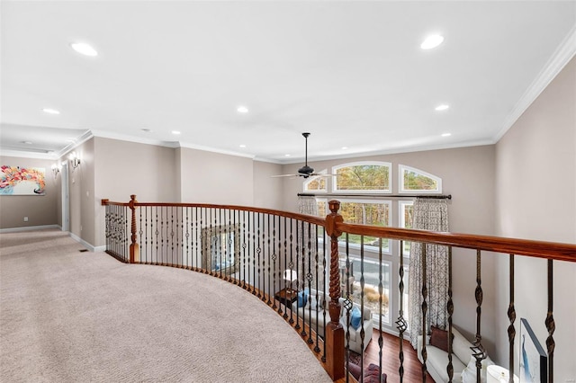 corridor with crown molding and carpet