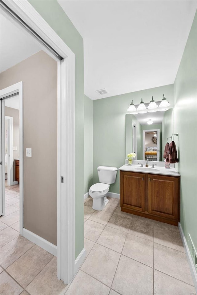 bathroom with vanity, toilet, and tile patterned floors