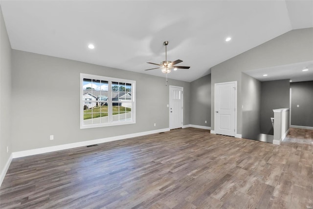 unfurnished living room with hardwood / wood-style floors, ceiling fan, and vaulted ceiling