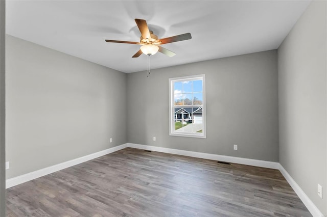 spare room featuring hardwood / wood-style floors and ceiling fan