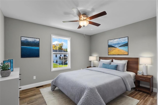 bedroom featuring ceiling fan and dark wood-type flooring