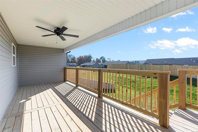 deck with a lawn and ceiling fan