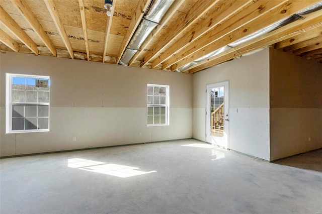 unfurnished room with concrete floors