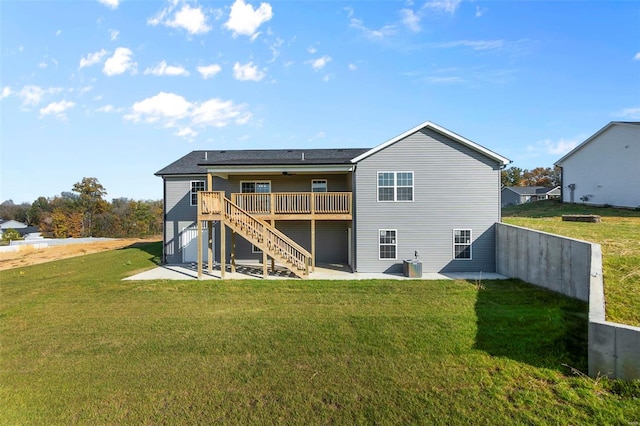 back of house featuring a yard, a deck, and a patio area