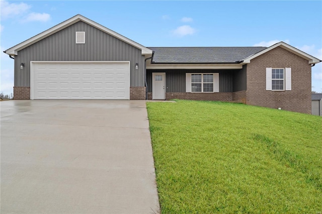 single story home with a garage and a front lawn