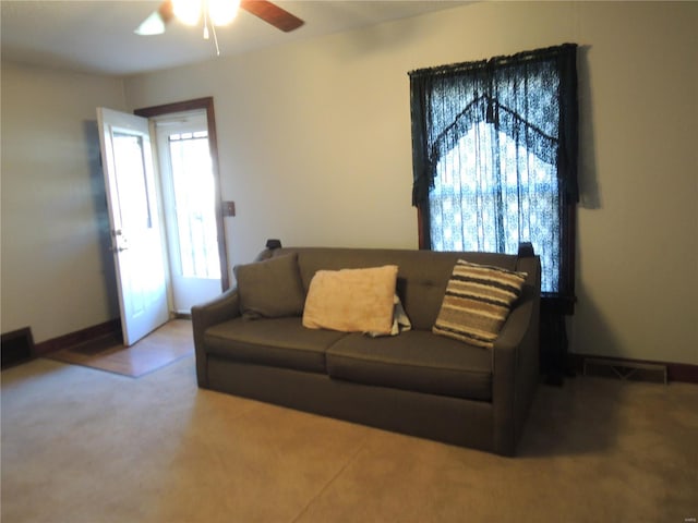 carpeted living room featuring ceiling fan