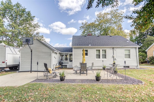 rear view of property with a lawn and a patio