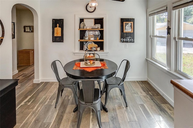 dining space featuring dark hardwood / wood-style flooring and a healthy amount of sunlight