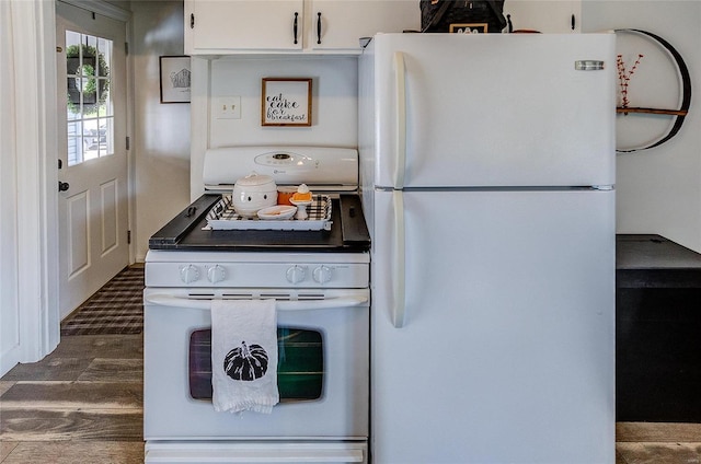 kitchen with white appliances and white cabinets