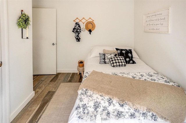 bedroom with dark hardwood / wood-style floors