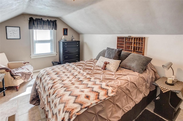 bedroom featuring lofted ceiling and light tile patterned floors