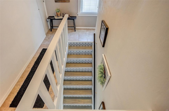 stairway with tile patterned floors