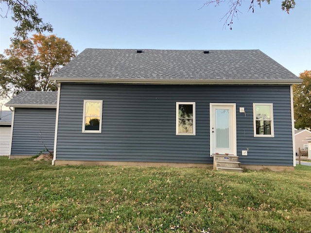 back of house with a lawn