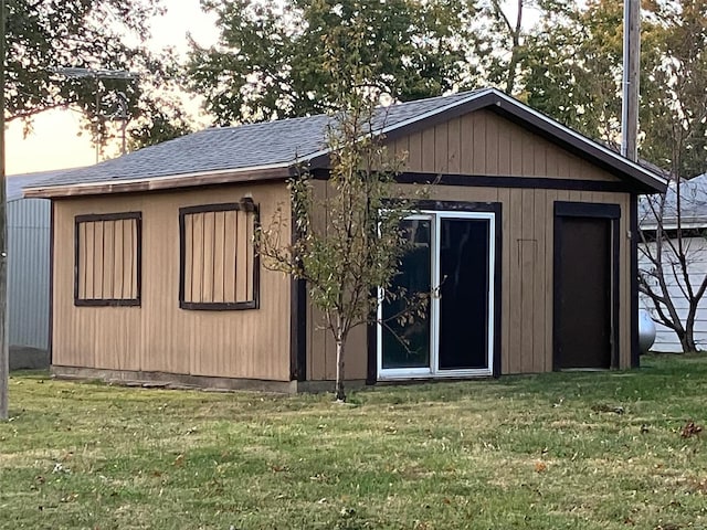 outdoor structure at dusk featuring a lawn