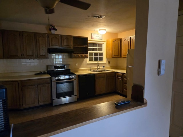 kitchen with gas range, dishwasher, sink, backsplash, and light tile patterned flooring