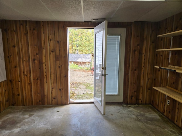 interior space with wooden walls and concrete floors