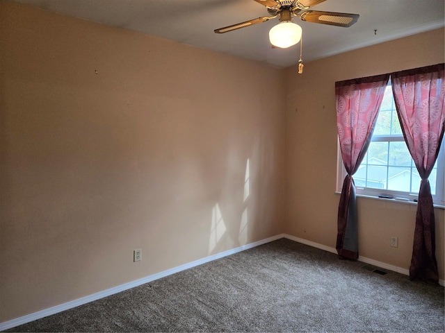 spare room featuring ceiling fan and carpet floors