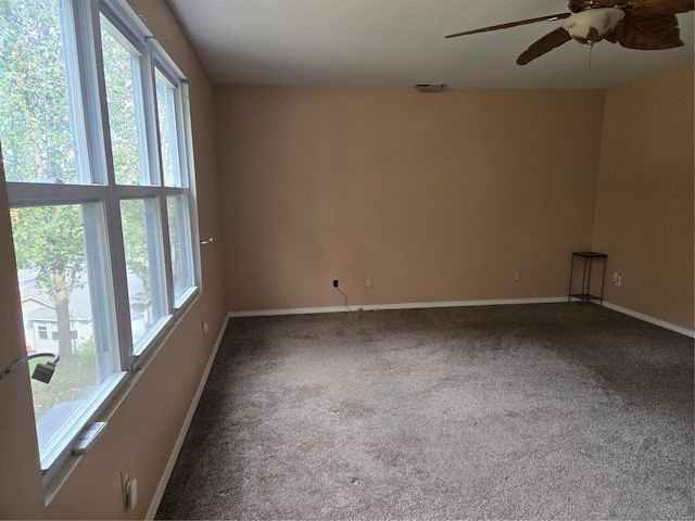 carpeted spare room featuring ceiling fan