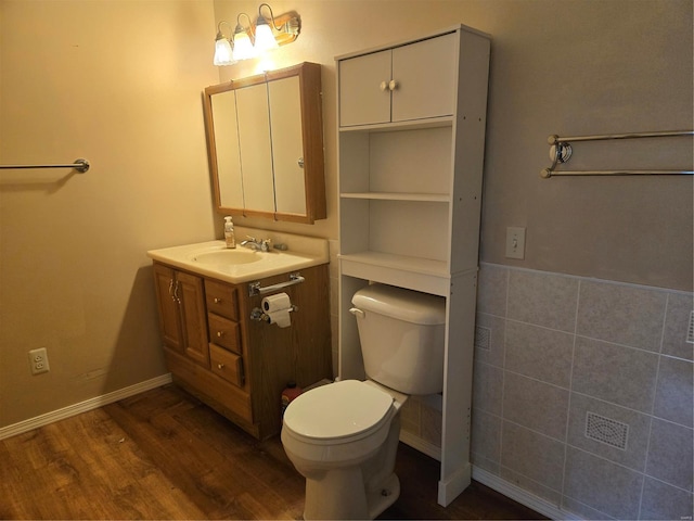 bathroom featuring hardwood / wood-style floors, vanity, and toilet