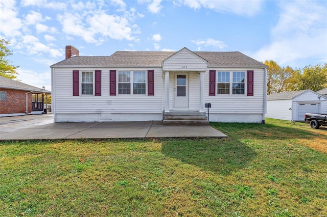 view of front facade featuring an outdoor structure, a front yard, and a garage