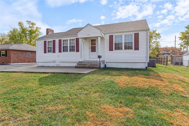 view of front of property featuring a front yard and cooling unit