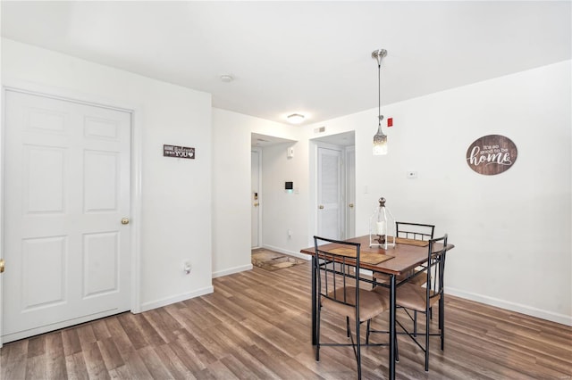 dining space with hardwood / wood-style floors